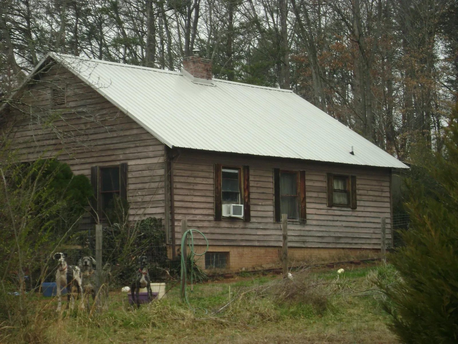 White metal roof on an old wood sided farmhouse, from a Metal Roof Installation job in Lowpoint